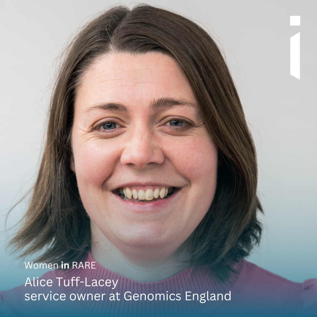 Headshot image of Alice Tuff-Lacey looking into the camera smiling. She has shoulder length brown hair and is wearing a pink jumper. The background is grey.