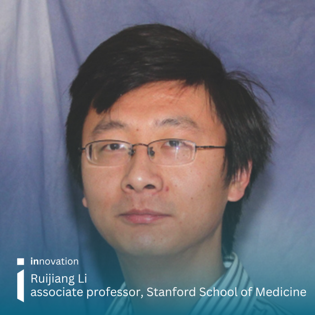 Headshot image of Ruijiang Li looking into the camera. He is in front of a blue material background and has small wire rimmed glasses. His hair is short and dark and he is wearing a striped shirt.