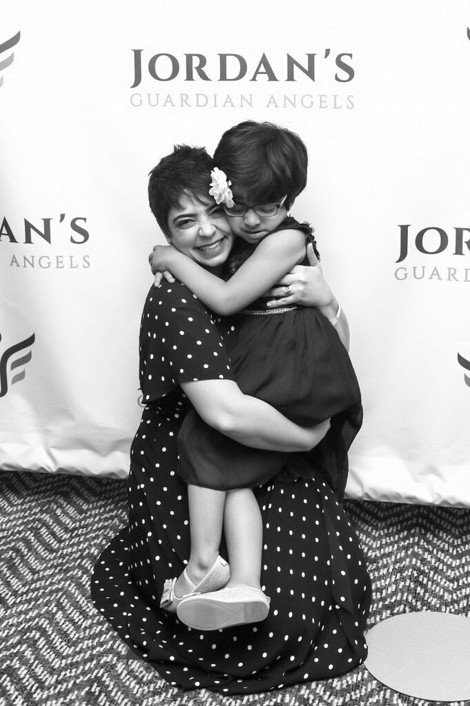 Carole, Simons Searchlight participant with a child at a Jordans Guardian Angels event
