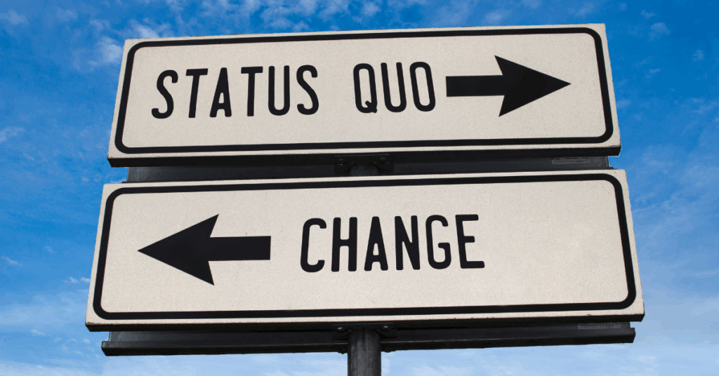 A picture of a road sign - one way points to "status quo" and the other points to change using imagery to convey the message that there is a crossroads in Phenylketonuria research and legislations