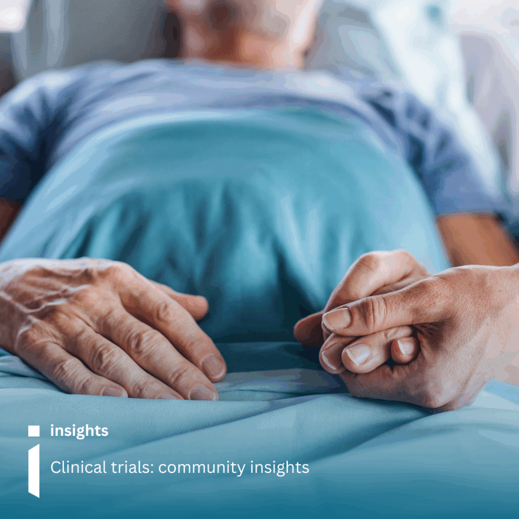 Image of a man in a hospital bed with his hand being held
