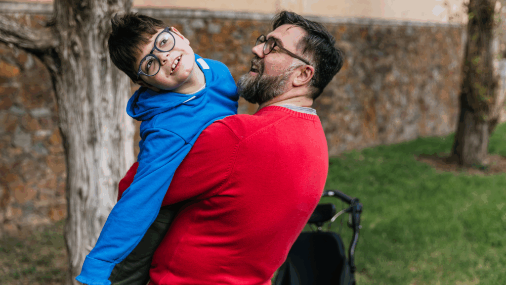 Image of a father holding his son with special needs