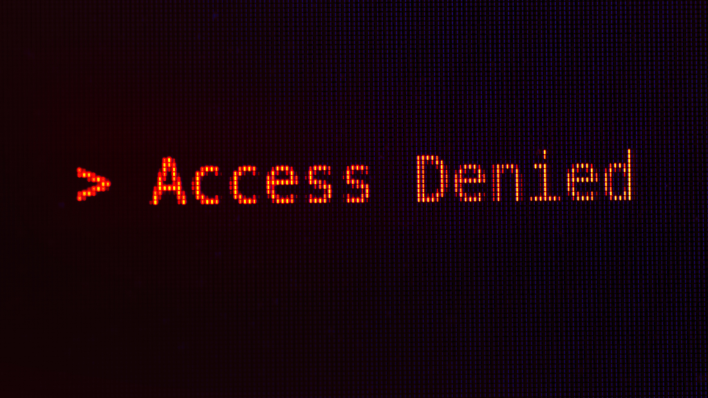 Image of typing on a computer screen saying access denied in red
