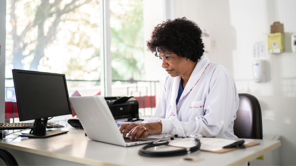 Photo of a female doctor sitting at her computer