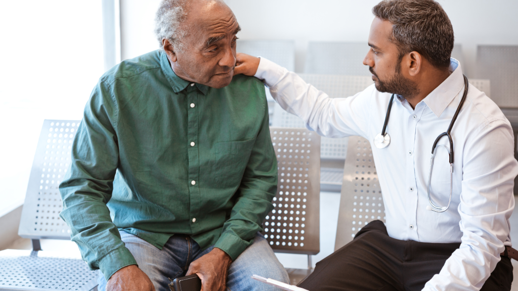 Photo of a doctor consoling his patient