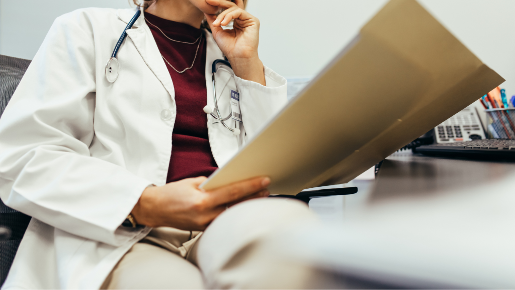 Photo of a doctor reading a file