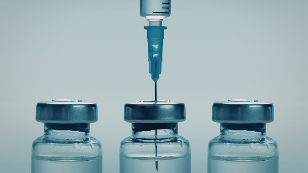 Image of three medicine vials with a needle going into the middle one