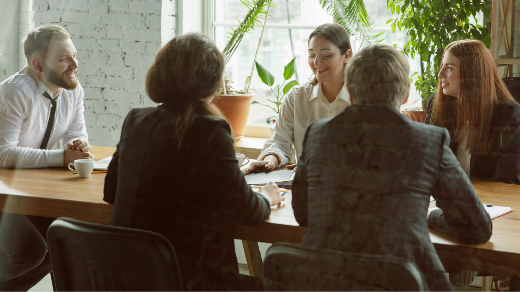 Photo of people talking around a business table
