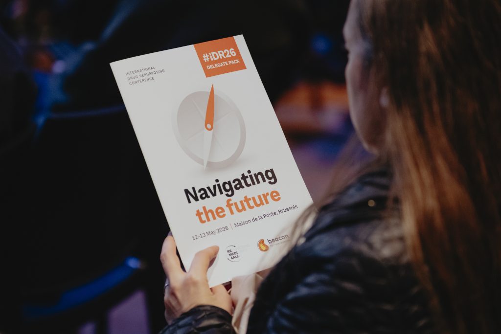 Photo of a delegate holding the conference brochure.