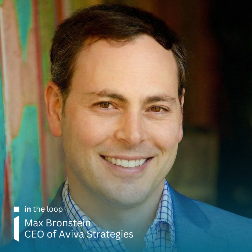 Image of Max Bronstein, CEO if Aviva Strategies wearing a chequered shirt and blazer