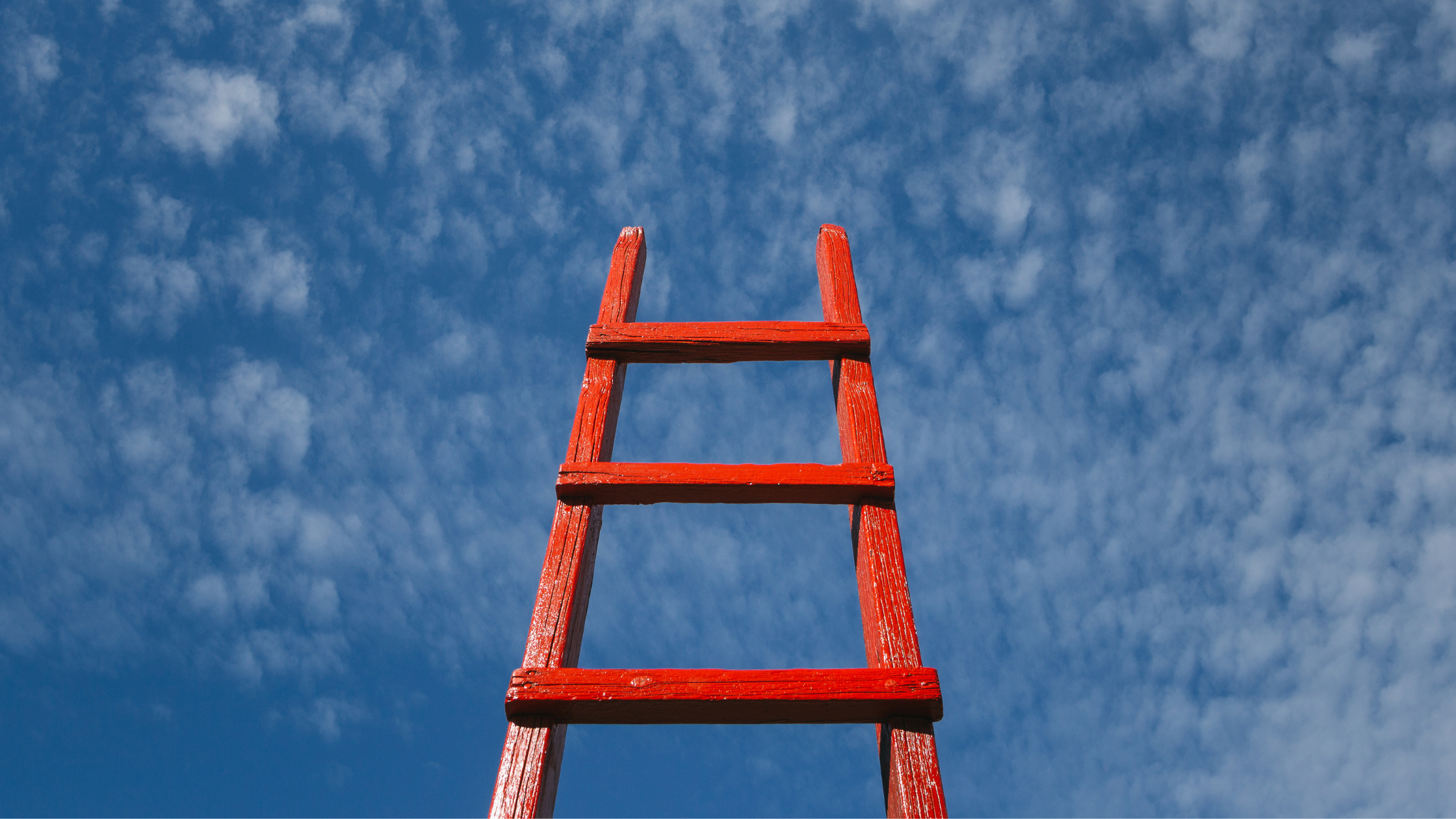 Photo of a ladder reaching into the sky