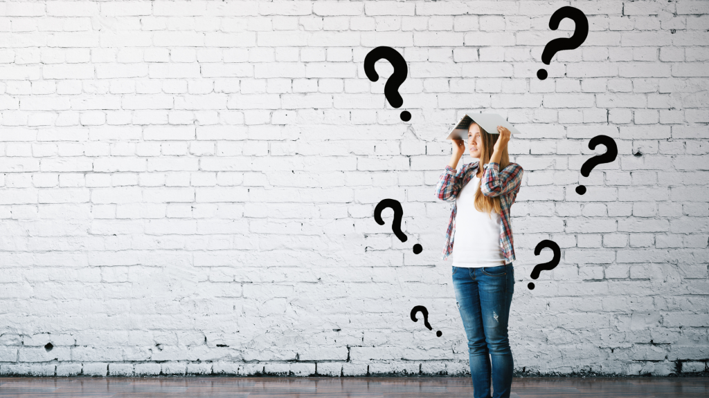Image of woman questioning her thoughts in front of a white wall