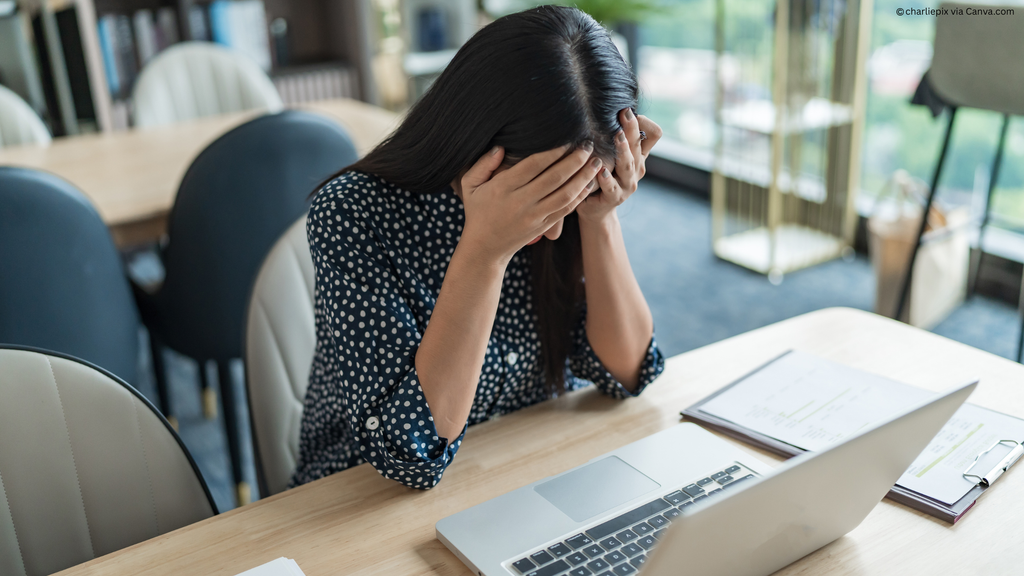 Image of a young person looking desperately at a laptop screen