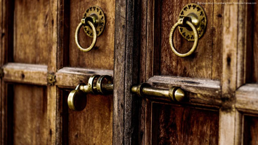 A photo of a large imposing locked door with big bolts