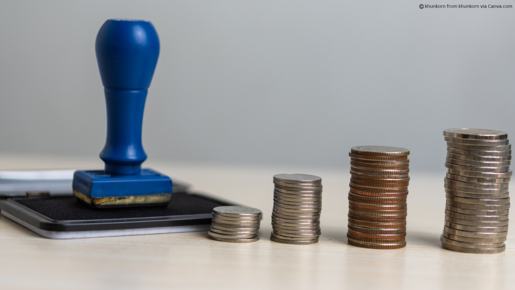 Photo of a decision stamp next to piles of money